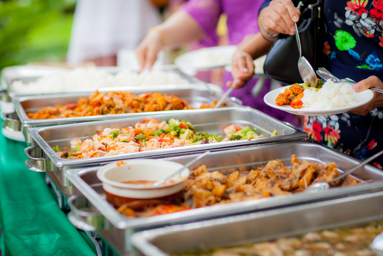 Guests serving themselves from a buffet spread